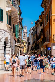 Verona, Veneto/Italy - 18.08.2020: Many tourists who are about to meet in a small street, although the danger of Covid 19 is in Verona.