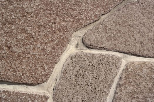 fragment of a wall of brown natural stone