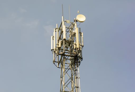 Mobile phone tower amid blue sky,vertical snapshot