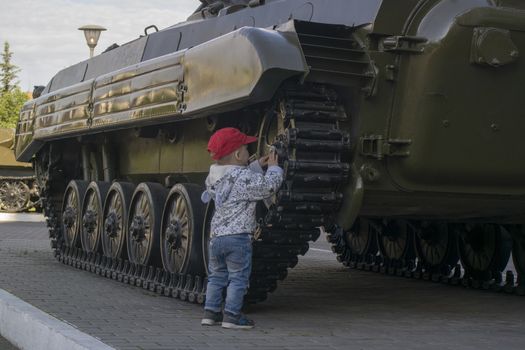 a small boy plays at the tank