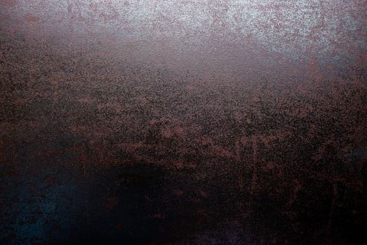rusted black steel sheet surface covered with machine oil in flat lay perspective