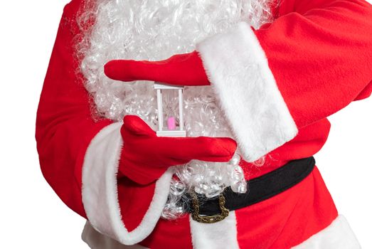 Santa Claus holding a white sand clock with both hands. Time is out. New year's eve concept. Isolated on white background.