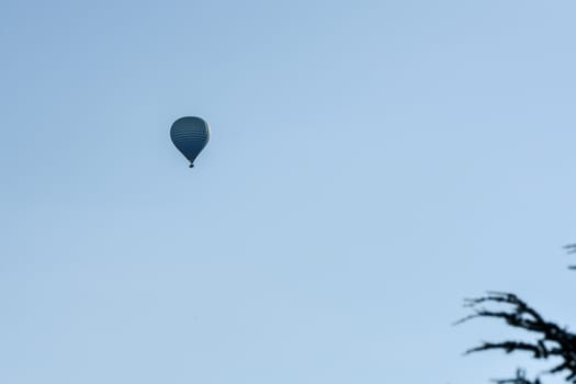 Colorful hot air balloons flying over the mountain in Puig Cerda, Spain.