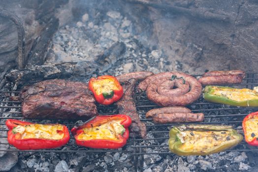 Closeup take of a traditional Argentinian and Uruguayan barbecue and peppers ehit eggs and cheese.