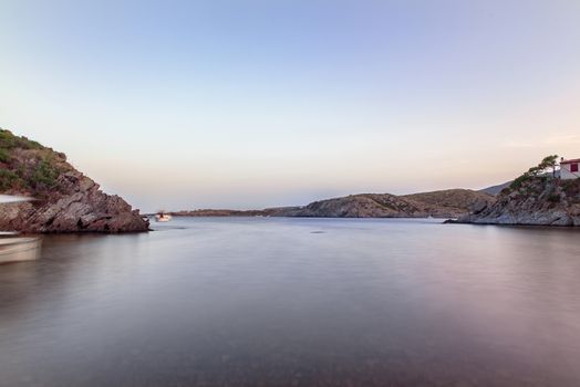 Cadaques, Spain :  2020 08 July : Spain Costa Brava peaceful pebble beach of the Mediterranean sea, Cala Guillola, Cadaques, Cap de Creus, Catalonia.