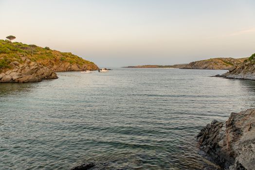 Cadaques, Spain :  2020 08 July : Spain Costa Brava peaceful pebble beach of the Mediterranean sea, Cala Guillola, Cadaques, Cap de Creus, Catalonia.