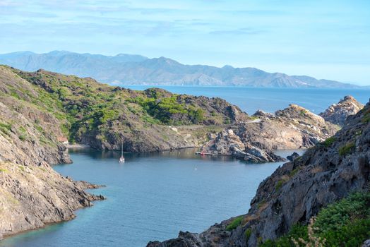 Sea landscape with Cap de Creus, natural park. Eastern point of Spain, Girona province, Catalonia. Famous tourist destination in Costa Brava. Sunny summer day with blue sky and clouds.