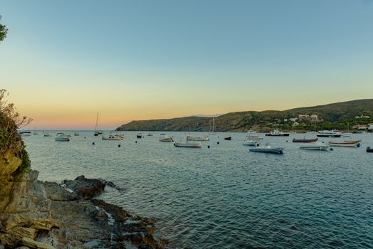 Boats in the beach and houses of the village of Cadaques, Spain.