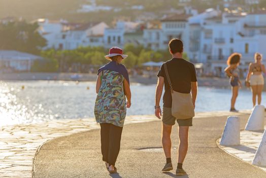 Cadaques, Spain : 07 JULY 2020 : People in the beach and houses of the village of Cadaques, Spain in summer on 07 july 2020.