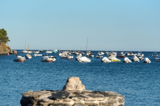 Cadaques, Spain : 07 JULY 2020 : Boats in the beach and houses of the village of Cadaques, Spain in summer on 07 july 2020.