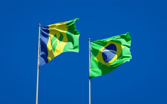 Beautiful national state flags of Saint Vincent and the Grenadines and Brasil together at the sky background. 3D artwork concept. 