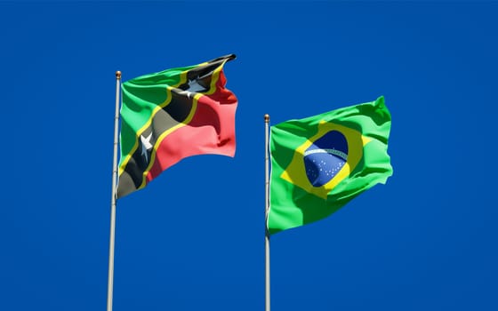 Beautiful national state flags of Saint Kitts and Nevis and Brasil together at the sky background. 3D artwork concept. 