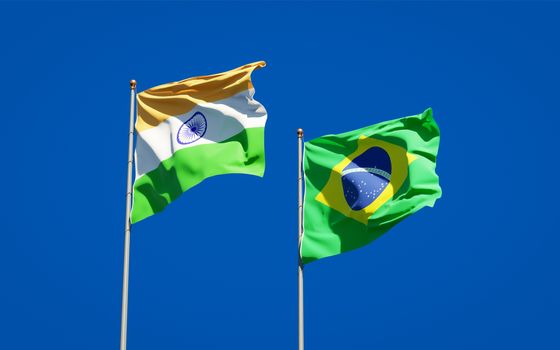 Beautiful national state flags of Brasil and India together at the sky background. 3D artwork concept. 