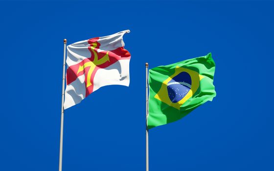 Beautiful national state flags of Guernsey and Brasil together at the sky background. 3D artwork concept. 