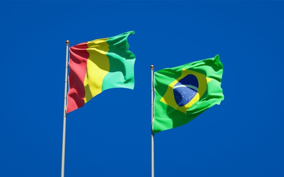 Beautiful national state flags of Guinea and Brasil together at the sky background. 3D artwork concept. 