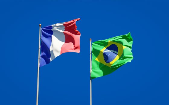 Beautiful national state flags of France and Brasil together at the sky background. 3D artwork concept. 