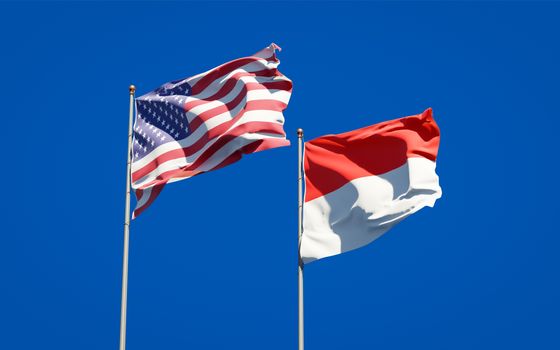 Beautiful national state flags of Indonesia and USA together at the sky background. 3D artwork concept. 