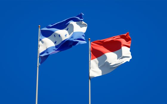 Beautiful national state flags of Honduras and Indonesia together at the sky background. 3D artwork concept. 