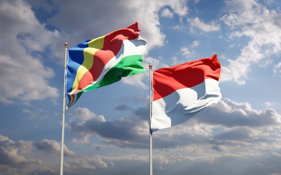 Beautiful national state flags of Seychelles and Indonesia together at the sky background. 3D artwork concept. 