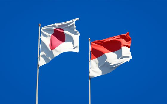 Beautiful national state flags of Japan and Indonesia together at the sky background. 3D artwork concept. 