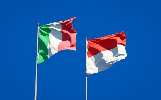 Beautiful national state flags of Italy and Indonesia together at the sky background. 3D artwork concept. 