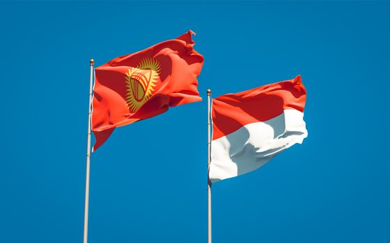 Beautiful national state flags of Kyrgyzstan and Indonesia together at the sky background. 3D artwork concept. 