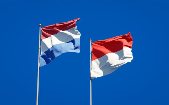 Beautiful national state flags of Netherlands and Indonesia together at the sky background. 3D artwork concept. 
