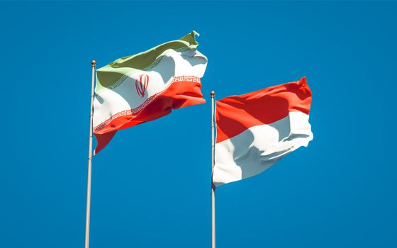 Beautiful national state flags of Iran and Indonesia together at the sky background. 3D artwork concept. 