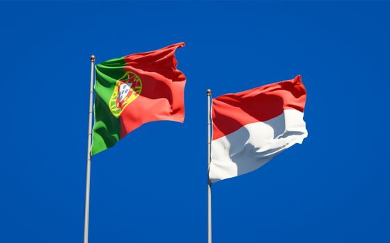Beautiful national state flags of Portugal and Indonesia together at the sky background. 3D artwork concept. 
