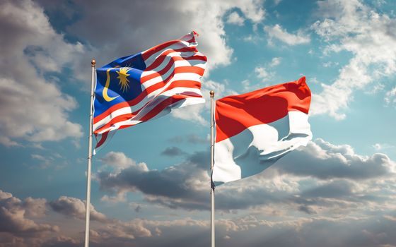 Beautiful national state flags of Malaysia and Indonesia together at the sky background. 3D artwork concept. 