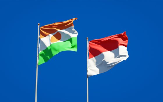 Beautiful national state flags of Niger and Indonesia together at the sky background. 3D artwork concept. 