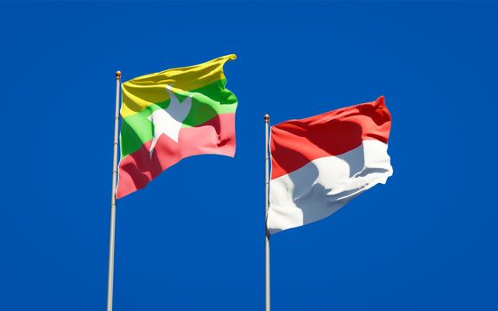 Beautiful national state flags of Myanmar and Indonesia together at the sky background. 3D artwork concept. 