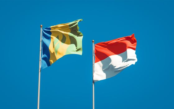 Beautiful national state flags of Saint Vincent and the Grenadines and Indonesia together at the sky background. 3D artwork concept. 