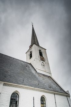 White church in Noordwijkerhout in the Netherlands with cloudy sky