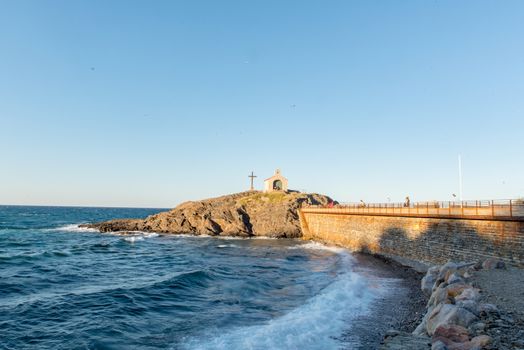 Tourists near chapel of Saint Vincent in sea of Collioure in south of France.