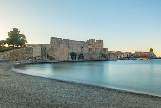 Coliure, France :  2020 june 22 :  Old town of Collioure, France, a popular resort town on Mediterranean sea, panoramic view with the Royal castle in sunrise light