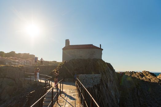 Colioure, France - July 21, 2020: Tourists near chapel of Saint Vincent in sea of Collioure in south of France.