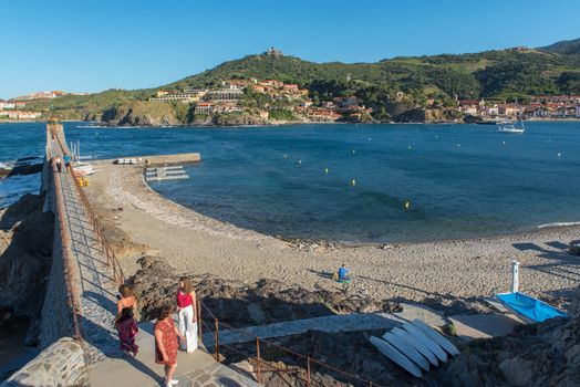 Colioure, France - July 21, 2020: Tourists near chapel of Saint Vincent in sea of Collioure in south of France.