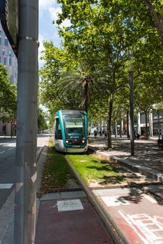 Barcelona, Spain - June 27 2020:  Train behind Glories shopping center is thought to be first shopping centers to have an open plan design incorporating outside space into its layout. behind Glories shopping center is thought to be first shopping centers to have an open plan design incorporating outside space into its layout.