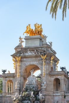 Buildings decorated with stucco and statues against the blue sky and white clouds. On the streets in Catalonia, public places.