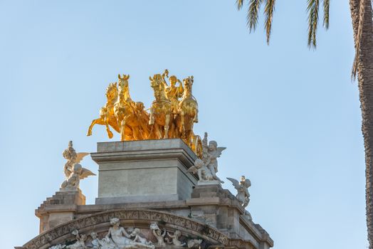 Buildings decorated with stucco and statues against the blue sky and white clouds. On the streets in Catalonia, public places.