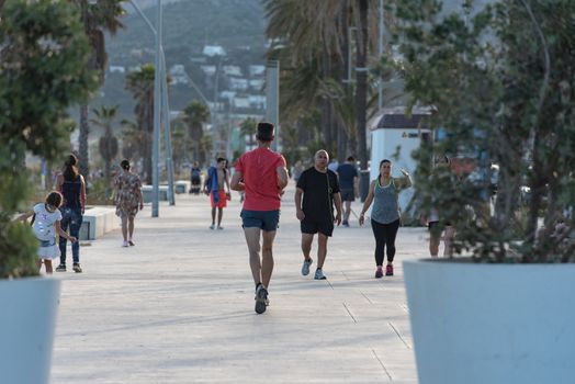 Castelldefels, Spain: 2020 June 25: People walk in the coastline of Castelldefels in Barcelona in summer after COVID 19 on June 2020.