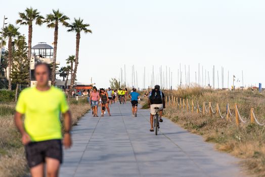 Castelldefels, Spain: 2020 June 25: People walk in the coastline of Castelldefels in Barcelona in summer after COVID 19 on June 2020.