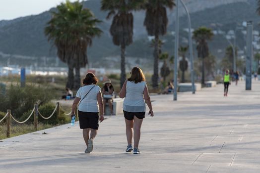 Castelldefels, Spain: 2020 June 25: People walk in the coastline of Castelldefels in Barcelona in summer after COVID 19 on June 2020.