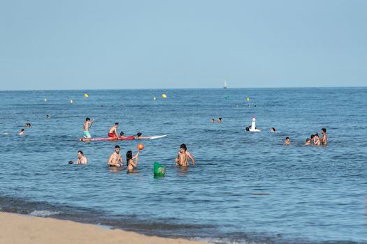 Castelldefels, Spain: 2020 June 25: People ride in Paddle Surf on the coast of Castelldefels in Barcelona in summer after COVID 19 on June 2020.