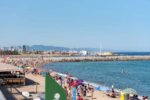 BARCELONA - JUNE 26, 2020: Barceloneta beach with people in summer after COVID 19 on June 26, 2020 in Barcelona, ​​Spain.