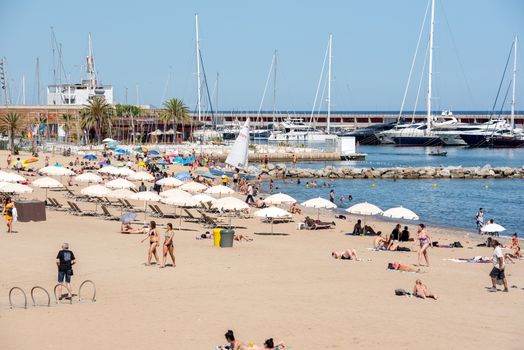 BARCELONA - JUNE 26, 2020: Barceloneta beach with people in summer after COVID 19 on June 26, 2020 in Barcelona, ​​Spain.