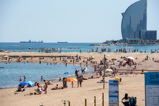 BARCELONA - JUNE 26, 2020: Barceloneta beach with people in summer after COVID 19 on June 26, 2020 in Barcelona, ​​Spain.