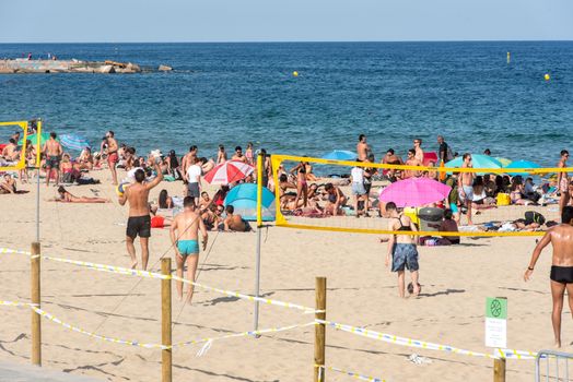 BARCELONA - JUNE 26, 2020: Platja de la Nova Icària beach with people in summer after COVID 19 on June 26, 2020 in Barcelona, ​​Spain.