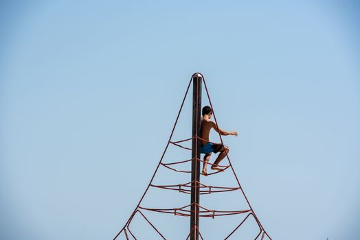 BARCELONA - JUNE 26, 2020: Children play in Barceloneta beach with people in summer after COVID 19 on June 26, 2020 in Barcelona, ​​Spain.